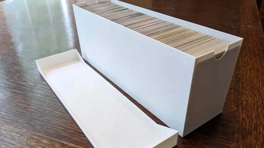 Image: 3D print of trading card container aside the container top